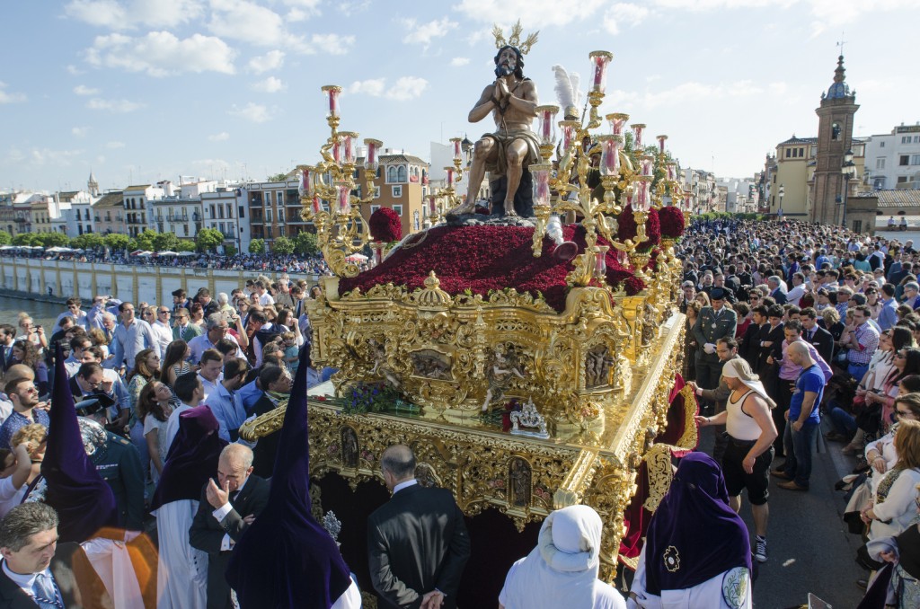 Holy Week in Seville, Spain.  The procession is seen here crossing the Bridge of Triana.